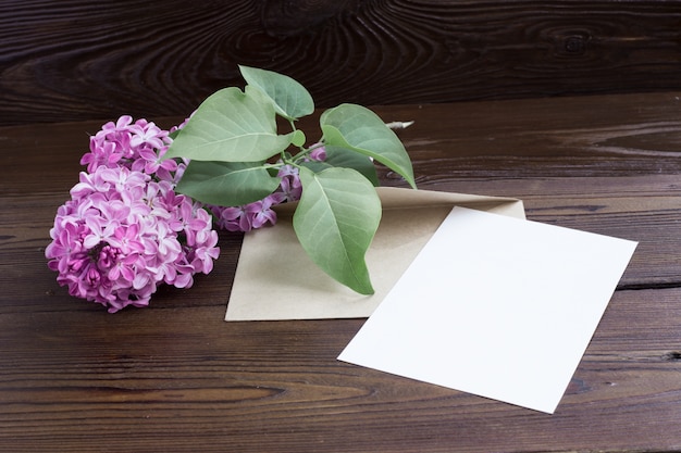 Lilac flowers on wooden table.