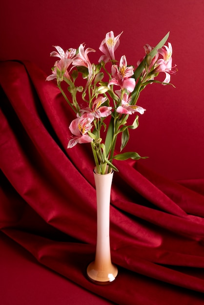 Lilies in vase with red background