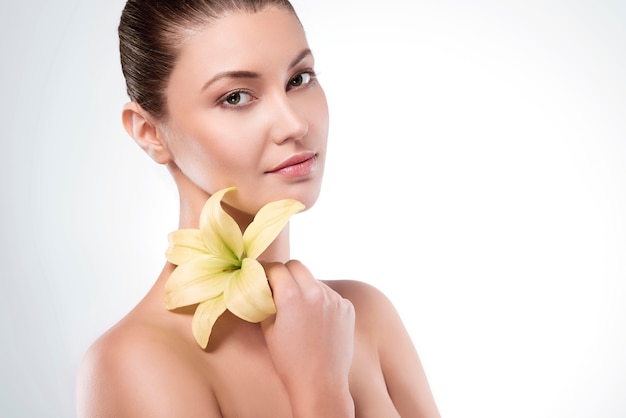 Lily flower held by an attractive woman