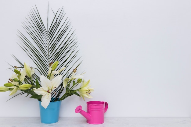 Lily flowers and watering pot