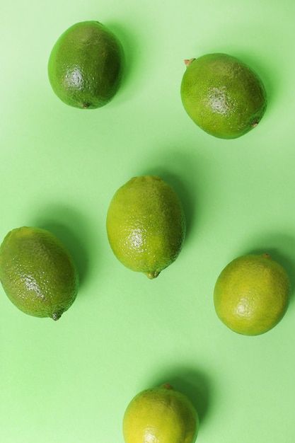 Lime fruit isolated on green surface