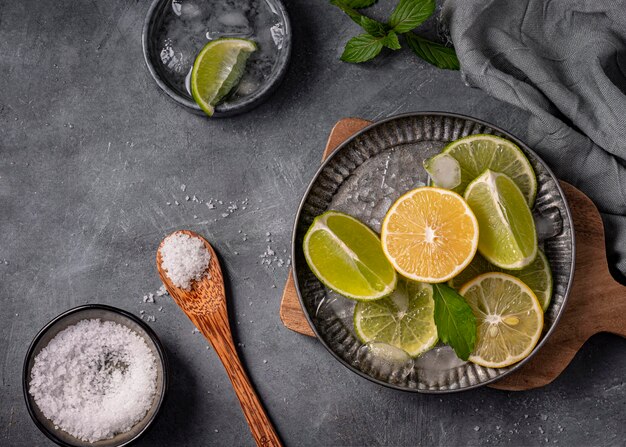 Lime and lemon slices on plate above view