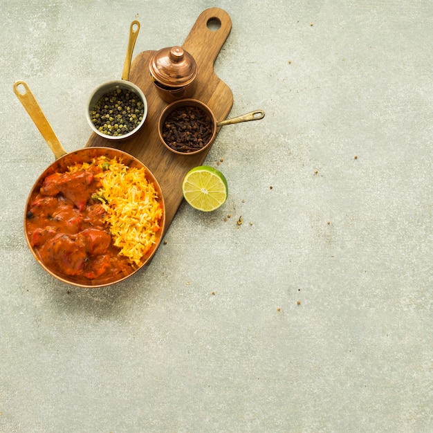 Lime and spices near tasty rice dish