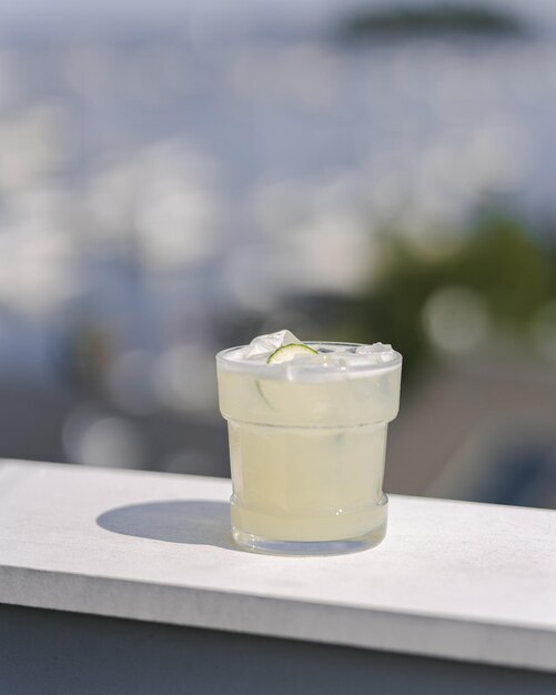 Limeade Fizz with alcohol and lime garnish at fancy rooftop bar