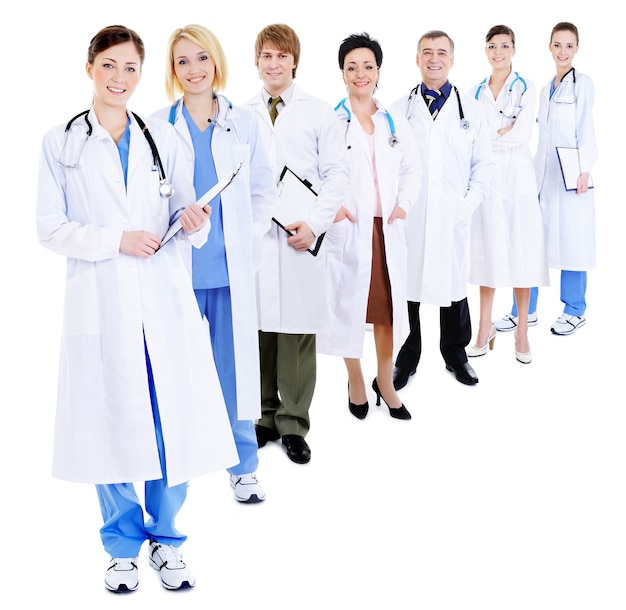 Line of group of happy doctors in hospital gowns- isolated on white