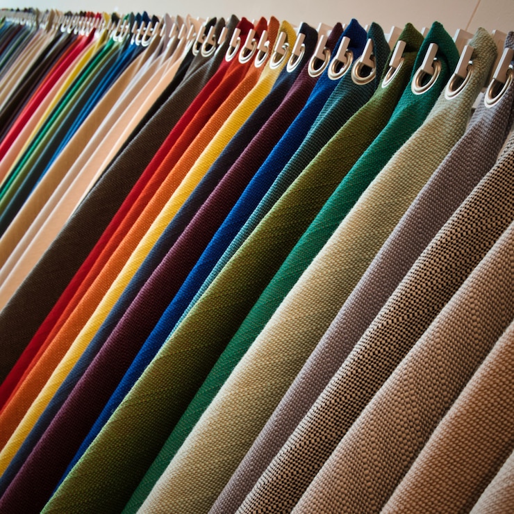 Free Photo line of hanging textured fabrics of different colors and shades