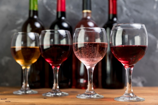 Free photo line of wine bottles and wineglasses