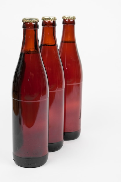 Lined up beer bottles on white background