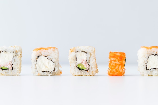 Lined up sushi rolls