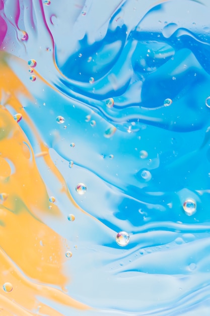 Liquid effect on the blue and yellow painted background