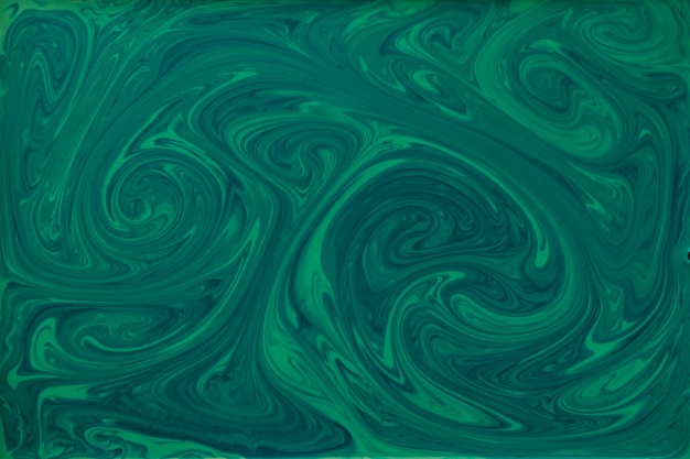 Free photo liquid green and black paint textured marbling backdrop