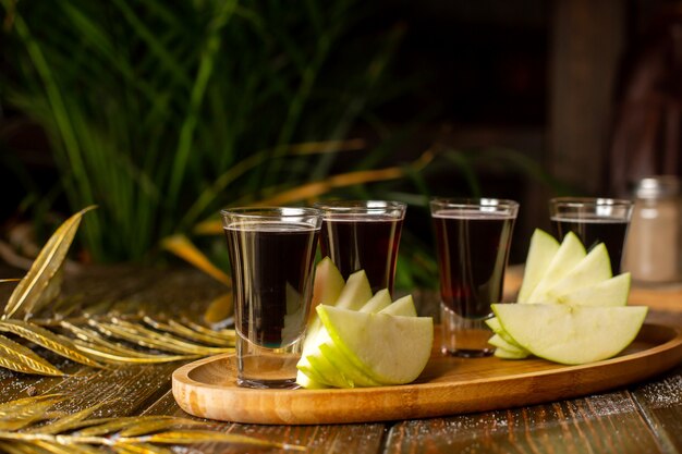 Liquor shots served with apple slices