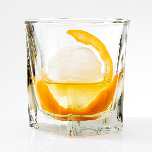 Liquour with an orange peel cocktail