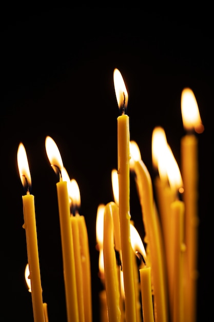 Lit candles with dark background still life