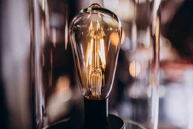 Lit lightbulb in the dark room