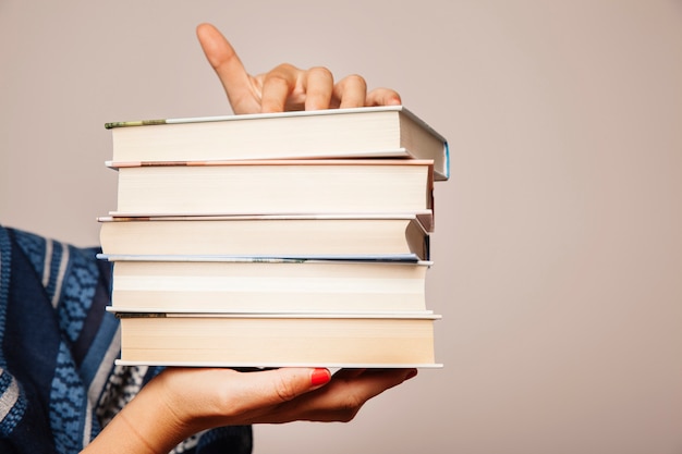 Literature composition with hands holding books