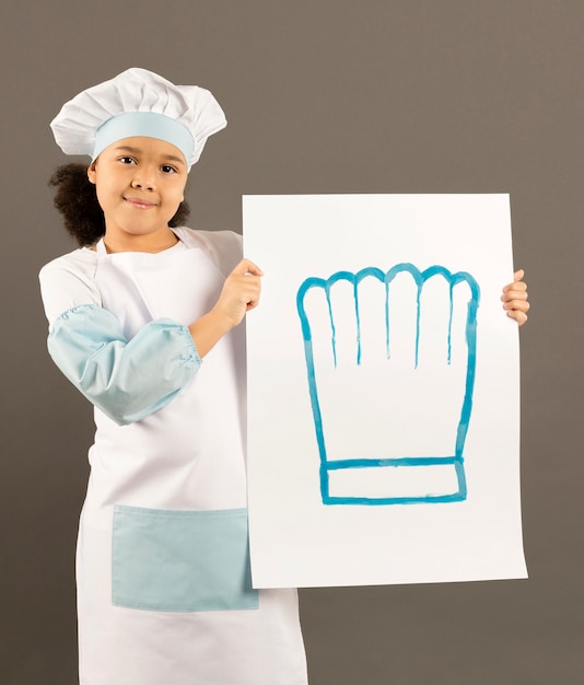 Little afroamerican chef holding banner