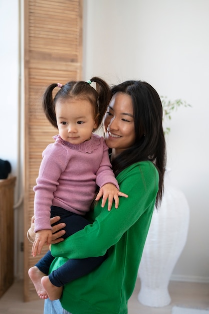 Little asian girl spending time at home with her mother