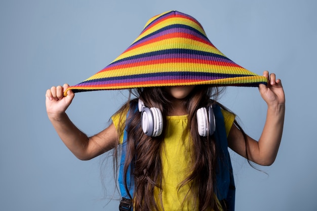 Little asian school girl with headphones portrait