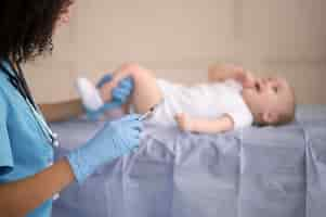 Free photo little baby being at the health clinic for vaccination