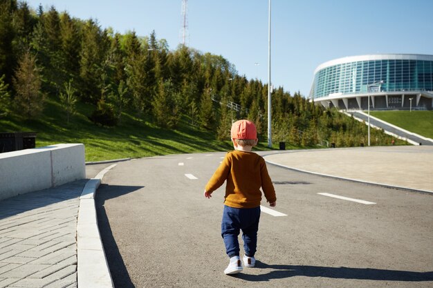 Little baby boy walking on the street