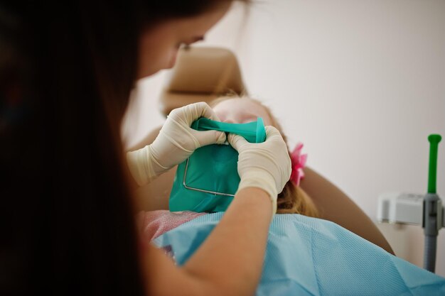 Little baby girl at dentist chair Children dental