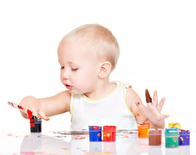 Little baby paint by his hands on white.