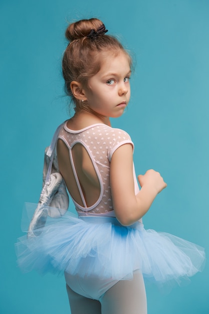 Free photo the little balerina dancer on blue background