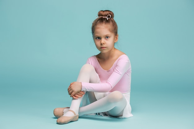 Free photo the little balerina dancer on blue background