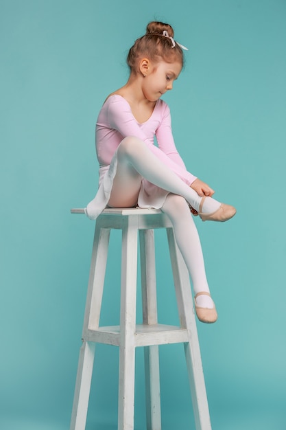 Free photo the little balerina dancer on blue background