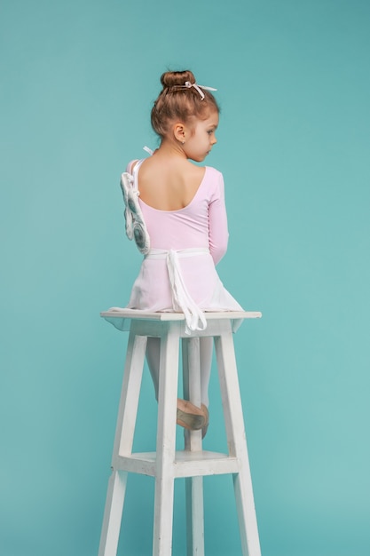 Free photo the little balerina dancer on blue background