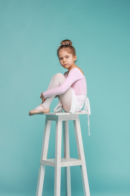 Free photo the little balerina dancer on blue background