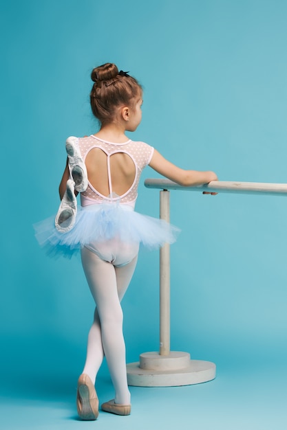 Free photo the little balerina dancer on blue background
