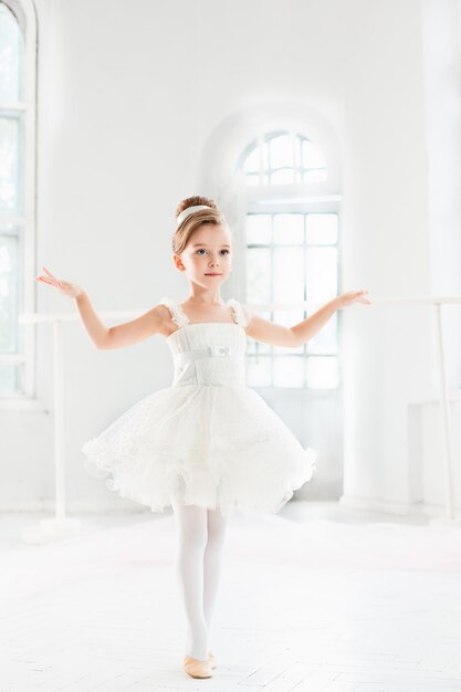 Маленькая балерина девушка в пачке. Очаровательный ребенок танцует классический балет