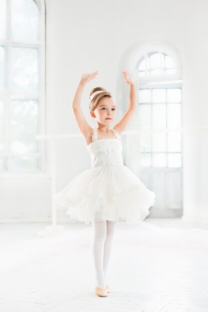 Little ballerina girl in a tutu. Adorable child dancing classical ballet