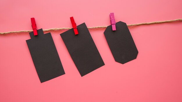 Little black paper tallies hanging on thread