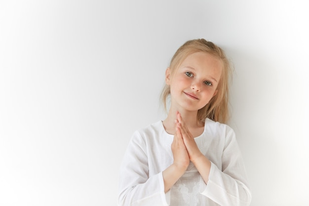 Little blonde girl wearing white blouse