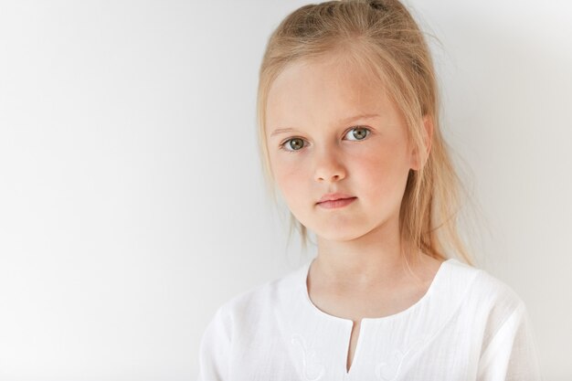 little blonde girl wearing white blouse