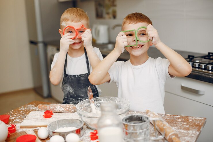 Free Photo little boy cook the dough for cookies
