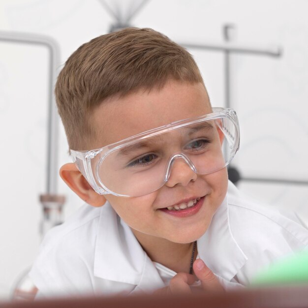 Little boy doing an experiment at school