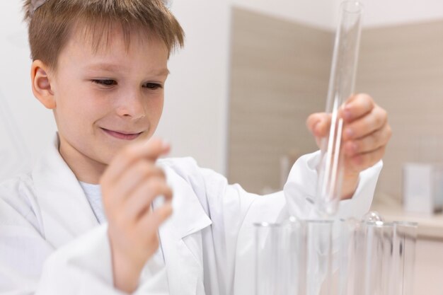 Little boy doing an experiment at school