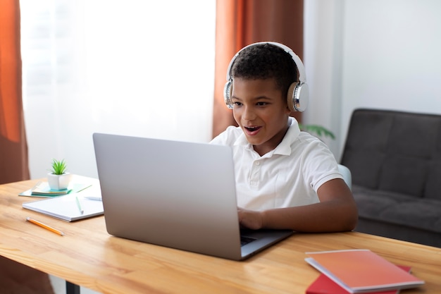 little boy doing school online