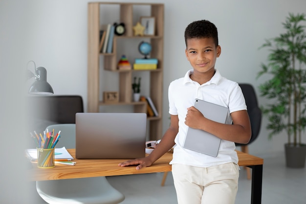 Little boy doing school online
