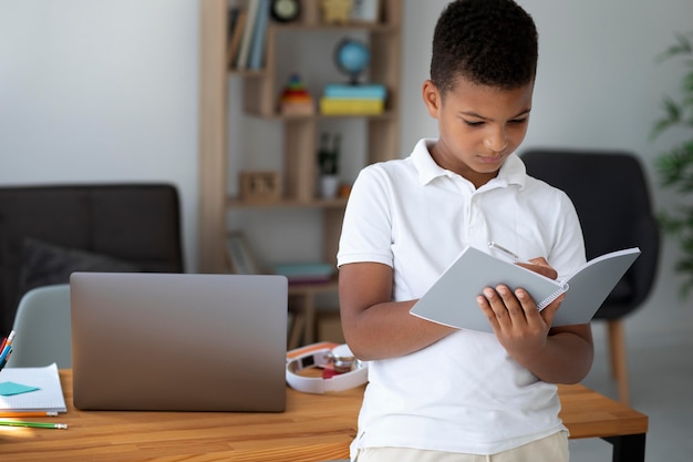 Little boy doing school online