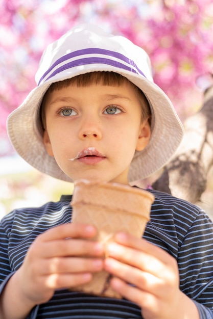 Free photo little boy eating ice cream