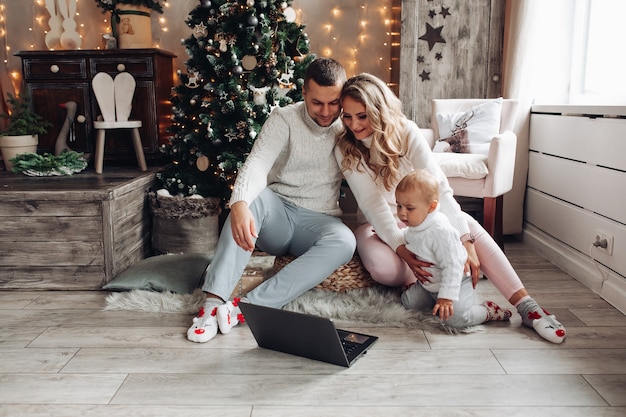 Little boy fascinatingly watches children's cartoons with parents