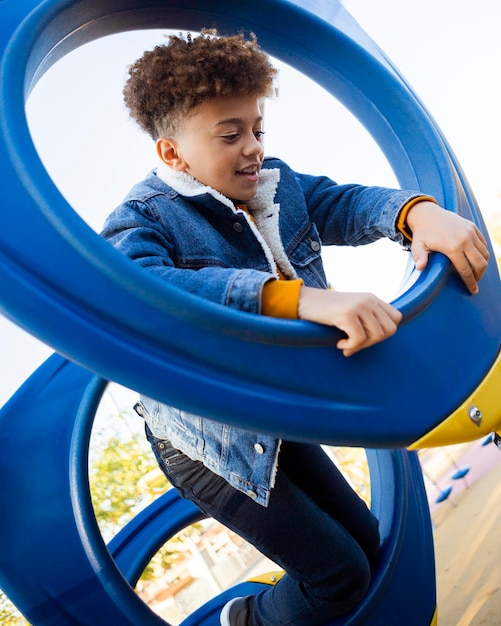 Little boy having fun at the playground outdoors