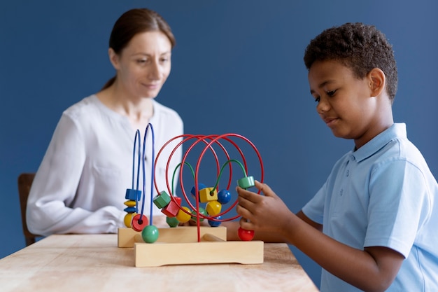 Little boy having an occupational therapy session with a psychologist