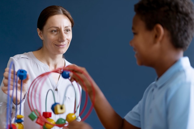 Free photo little boy having an occupational therapy session with a psychologist