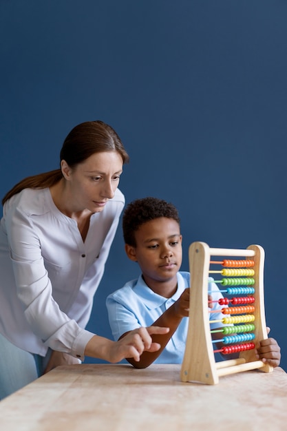 Little boy having an occupational therapy session with a psychologist